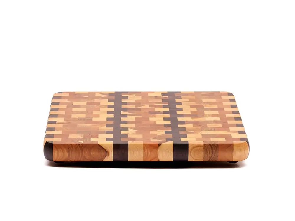 Front view of an end-grain cutting board with a checkered pattern of various wood tones, featuring rounded corners and a smooth finish, against a white background