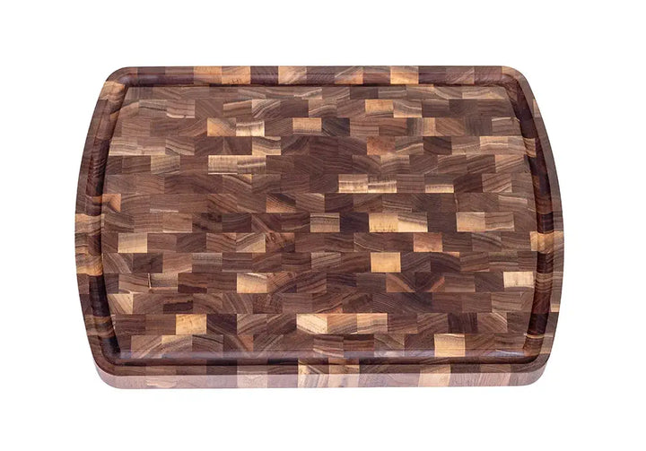 A top-down view of a wooden cutting board featuring a striking end-grain pattern with a variety of natural brown tones. The board is bordered by a juice groove, highlighting its functional and visually appealing craftsmanship.