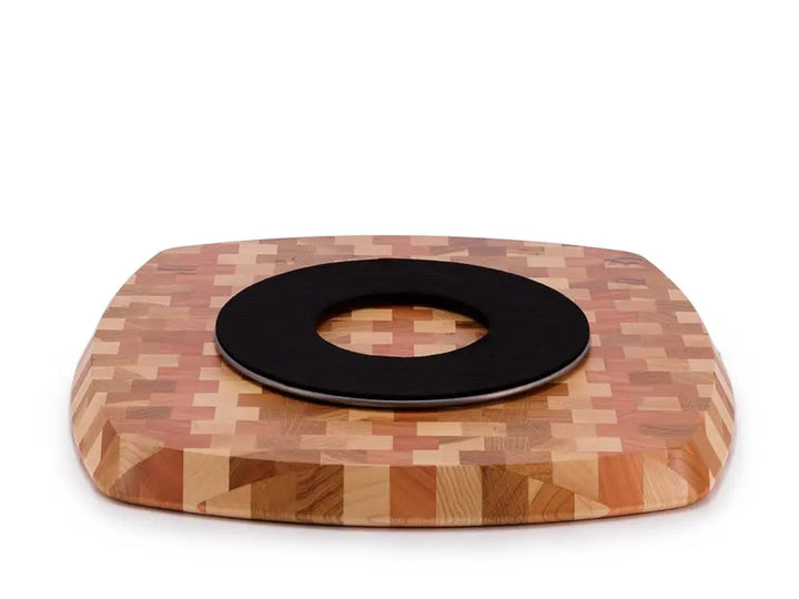 Bottom view of a rectangular end-grain lazy susan with rounded corners, featuring a geometric mosaic pattern in various shades of light and reddish-brown wood, showing a black protective felt pad, on a white background