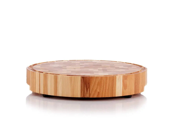 Front view of a round hickory nut end grain butcher block with a juice groove, showcasing a multicolored wood pattern and black rubber feet