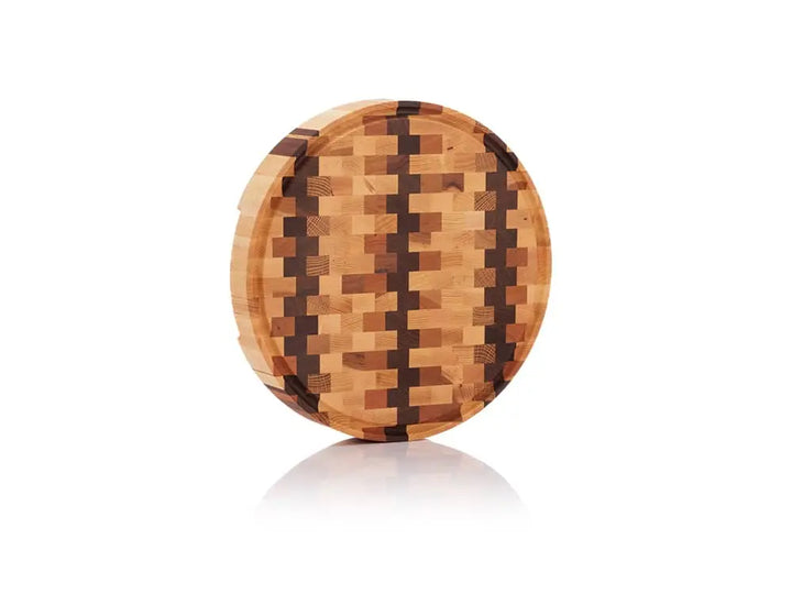 Round end grain butcher block with a checkered pattern, shown standing on its edge against a white background