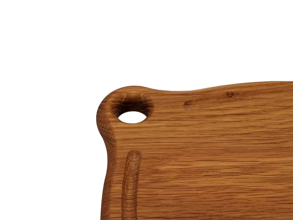 Close-up of the Iron Wood White Oak Trivet handle, showcasing the smooth finish and grommet hole
