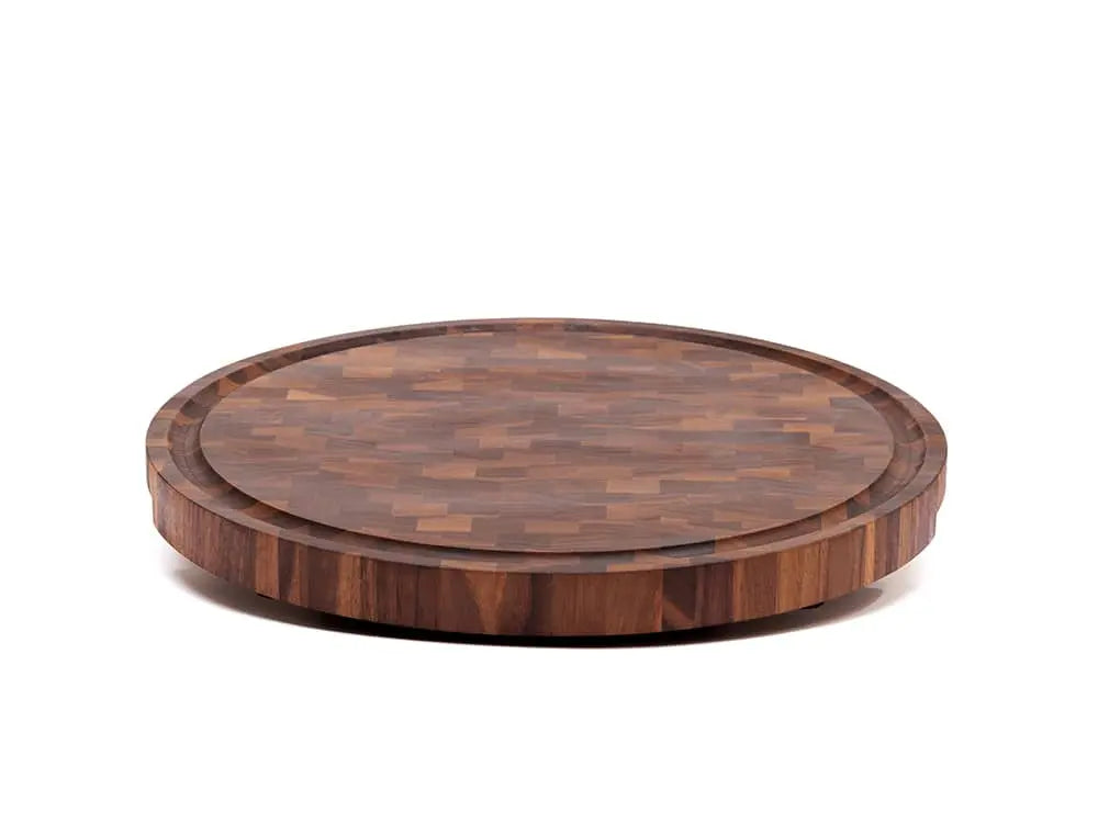 Front view of a round black walnut end-grain cutting board with a checkered pattern of various wood tones, featuring a smooth finish, against a white background