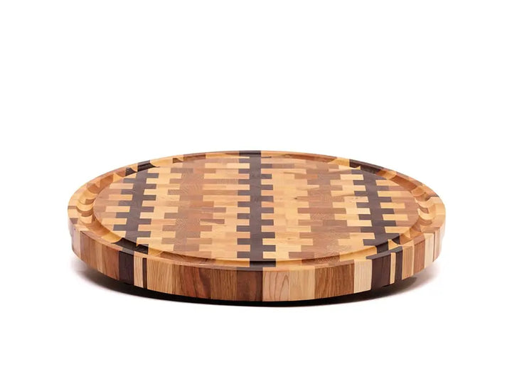 Front view of a round end-grain cutting board with a checkered pattern of various wood tones, featuring a smooth finish, against a white background