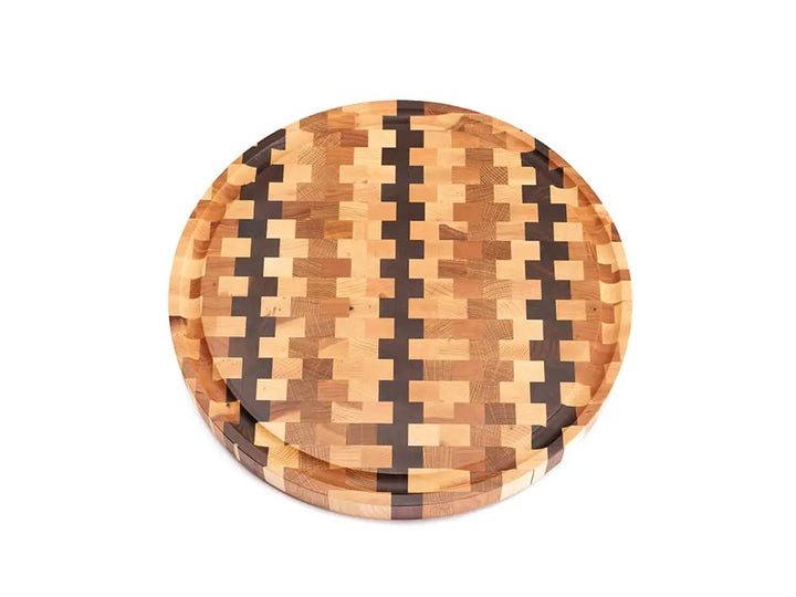 Top view of a round end-grain cutting board with a checkered pattern of various wood tones, featuring a smooth finish, against a white background