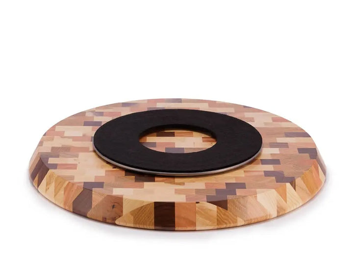 Close-up view of the underside of a round end-grain lazy susan, showing a black protective felt pad, on a white background