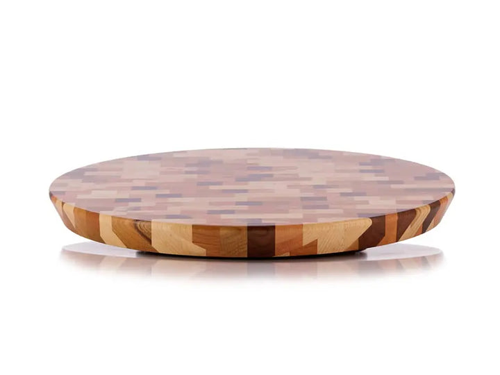 Front view of a round end-grain lazy susan with a geometric mosaic pattern in various shades of brown and beige wood, on a white background