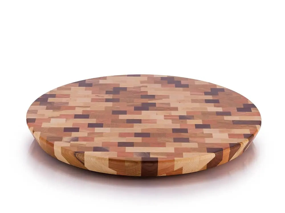 Top view of a round end-grain lazy susan with a geometric mosaic pattern in various shades of brown and beige wood, on a white background
