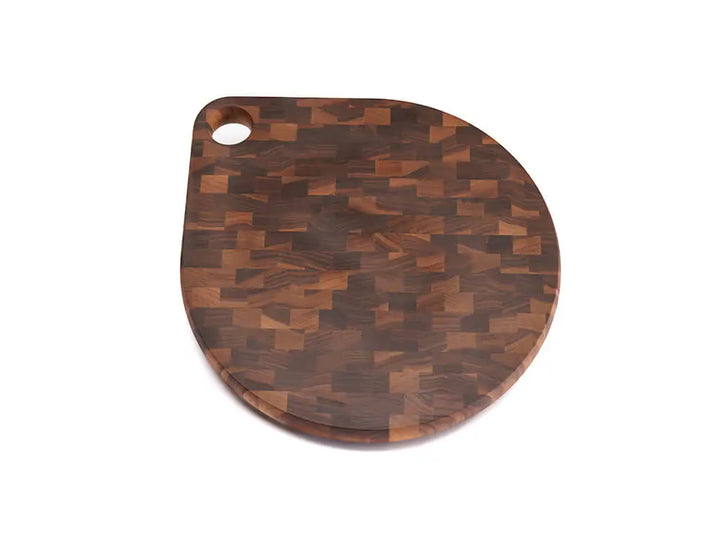 Top view of a black walnut end-grain charcuterie board with a checkered pattern of various wood tones, featuring a smooth finish, against a white background