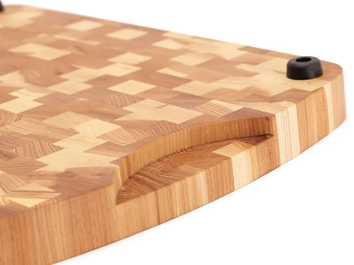 Bottom view of a Hickory Nut end grain cutting board with a checkered pattern and rounded edges, against a white background