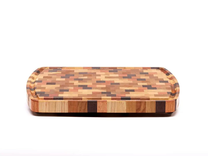 Front view of an end-grain cutting board with a checkered pattern of various wood tones, featuring rounded corners and a smooth finish, against a white background
