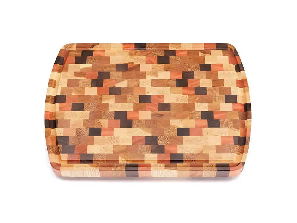 Top view of an end-grain cutting board with a checkered pattern of various wood tones, featuring rounded corners and a smooth finish, against a white background